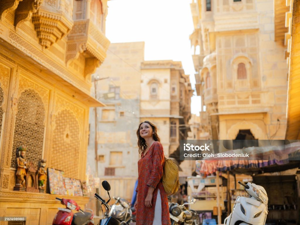 Cheerful woman  walking on crowded street in old town of Jaisalmer, India